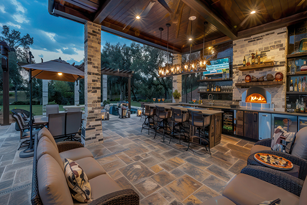 Outdoor kitchen next to a pool deck.